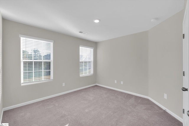 carpeted empty room featuring plenty of natural light