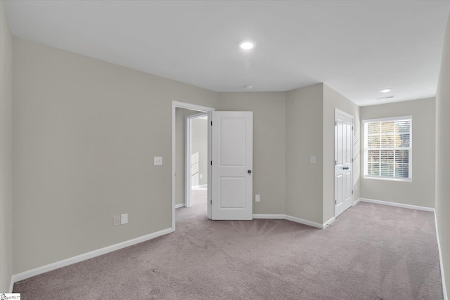 unfurnished room with light colored carpet