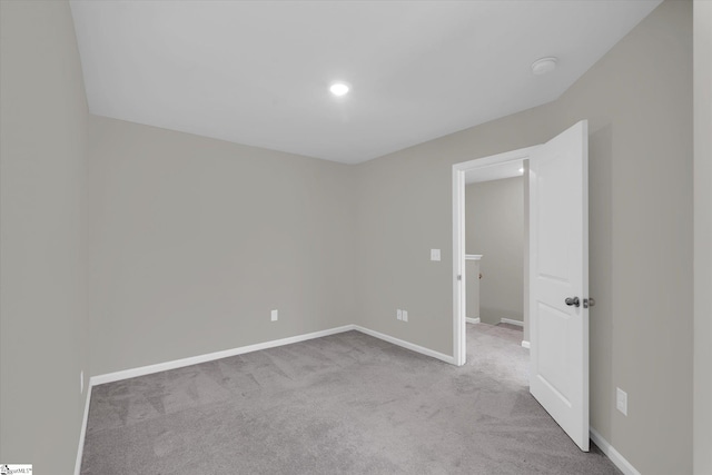 unfurnished room with light carpet