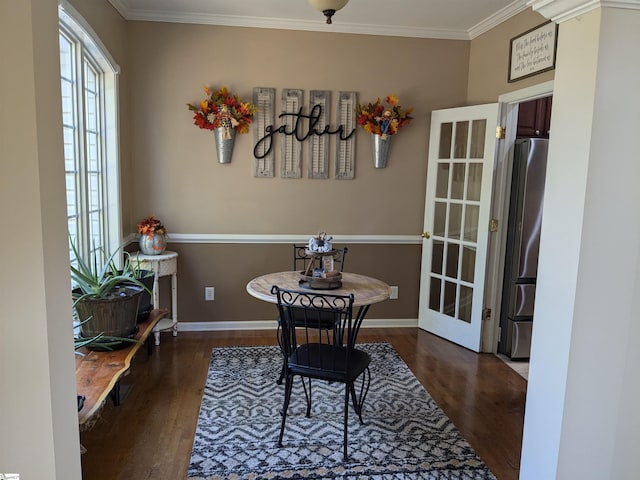 dining space with crown molding and dark hardwood / wood-style flooring