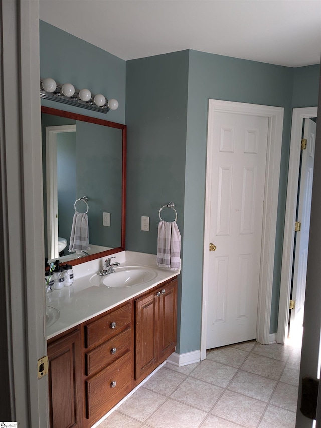 bathroom featuring toilet, vanity, and tile patterned floors