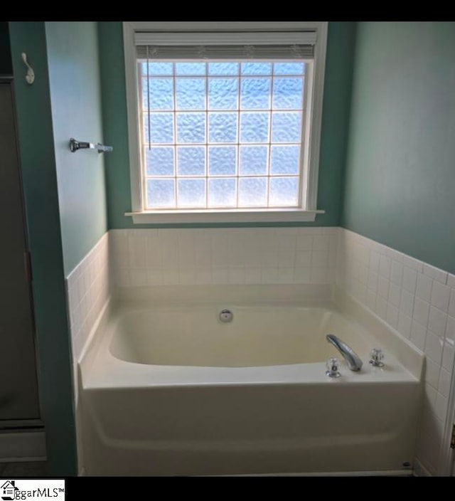 bathroom featuring a tub to relax in