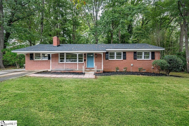 ranch-style home with a porch and a front lawn