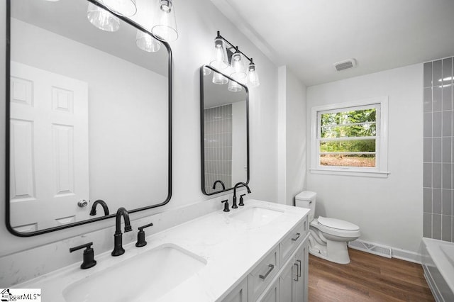 bathroom featuring vanity, hardwood / wood-style floors, and toilet