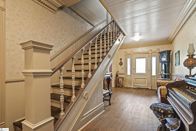 stairway featuring crown molding and hardwood / wood-style floors