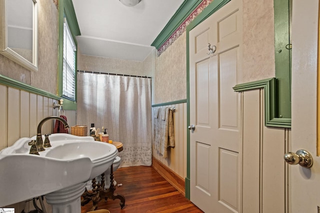 bathroom with curtained shower and hardwood / wood-style flooring