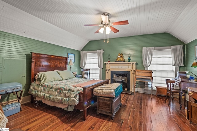 bedroom with vaulted ceiling, dark hardwood / wood-style floors, and ceiling fan