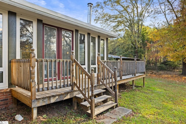 entrance to property featuring a yard and a deck