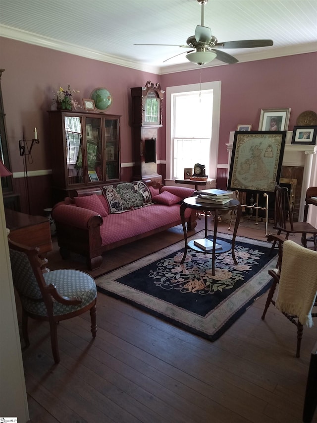 living room with ornamental molding, wood-type flooring, and ceiling fan