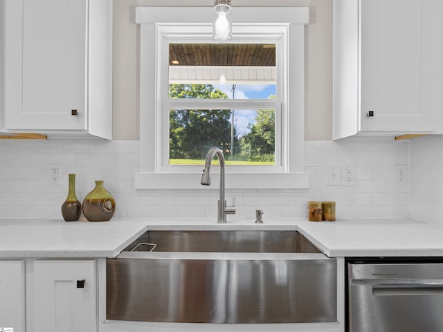 kitchen with sink, tasteful backsplash, dishwasher, and white cabinets