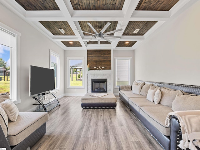 living room with coffered ceiling, wood-type flooring, and a wealth of natural light