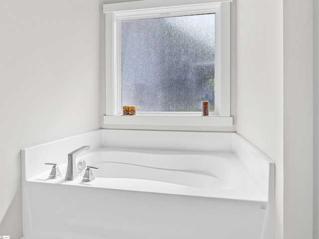 bathroom with a tub to relax in