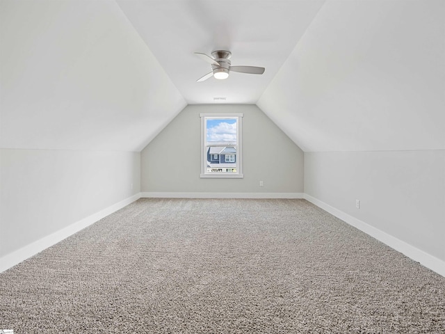 additional living space with ceiling fan, carpet, and vaulted ceiling