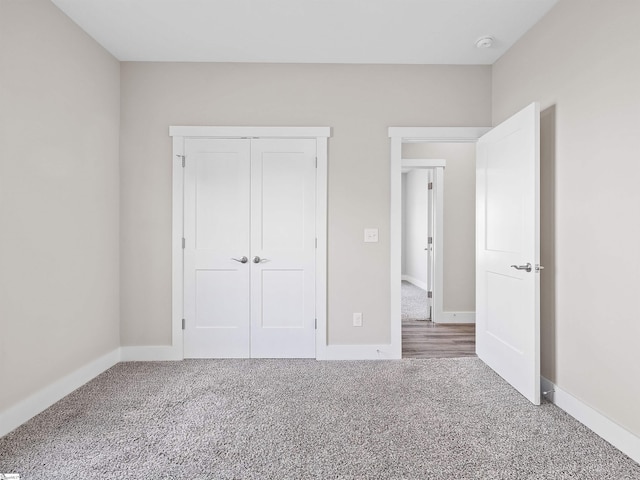 unfurnished bedroom with a closet and carpet flooring