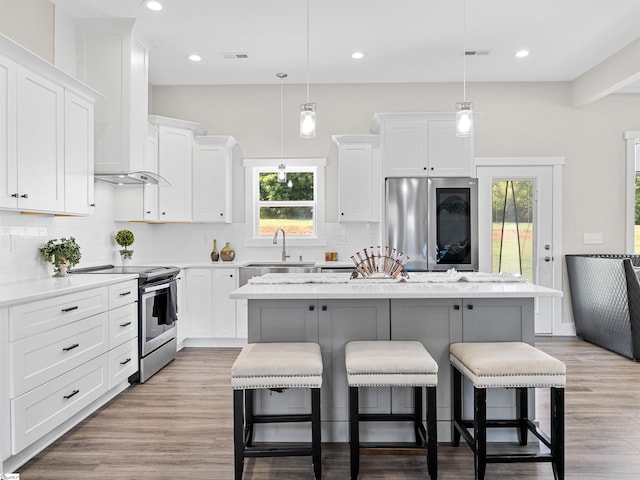 kitchen featuring a kitchen island, white cabinetry, and stainless steel appliances