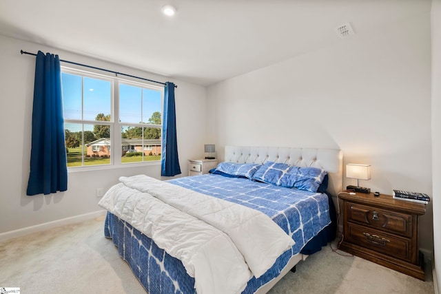 bedroom featuring light carpet