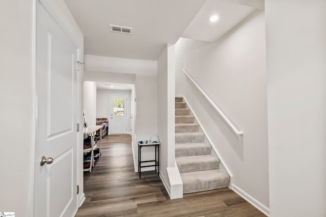 stairway with hardwood / wood-style floors