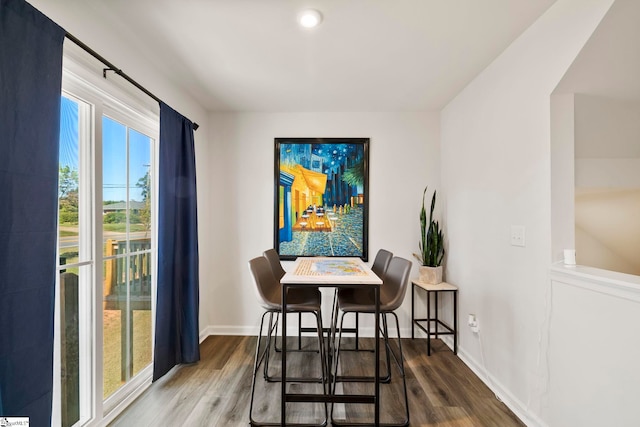 dining space with wood-type flooring