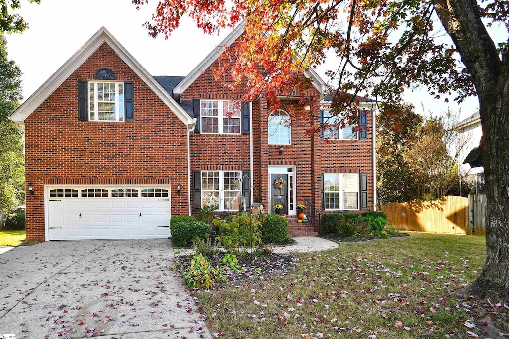 view of front of house featuring a front yard and a garage
