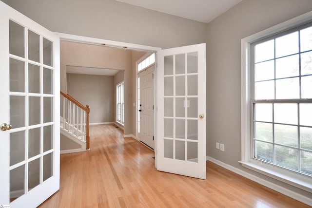 entrance foyer featuring french doors and light wood-type flooring