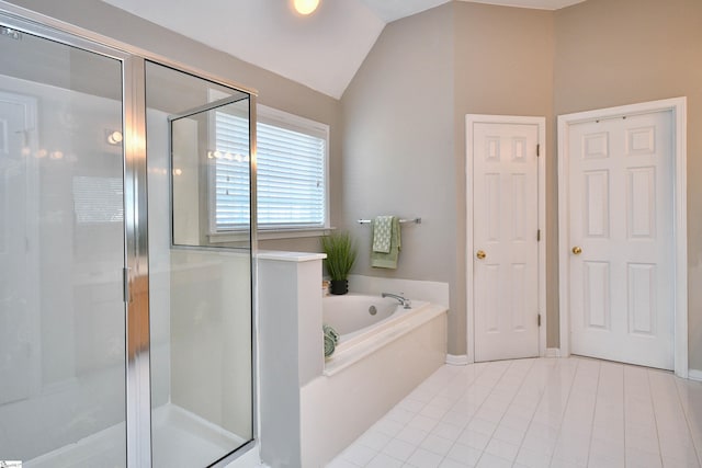 bathroom featuring tile patterned flooring, lofted ceiling, and separate shower and tub