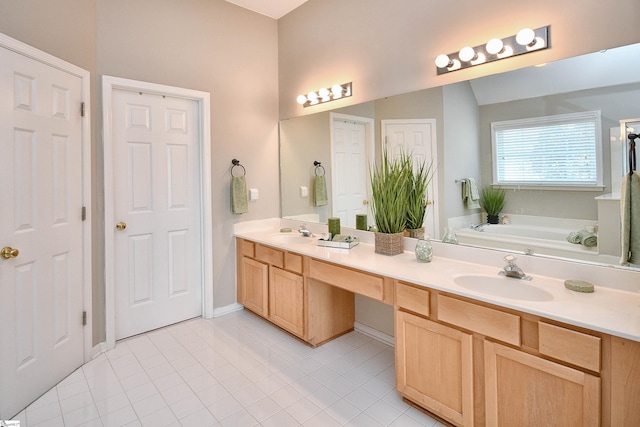 bathroom with vanity, vaulted ceiling, a bathtub, and tile patterned flooring