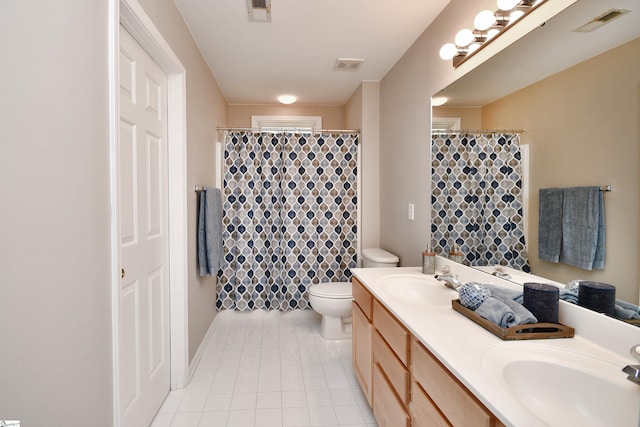 bathroom featuring vanity, toilet, and tile patterned floors