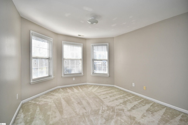 carpeted empty room with a healthy amount of sunlight