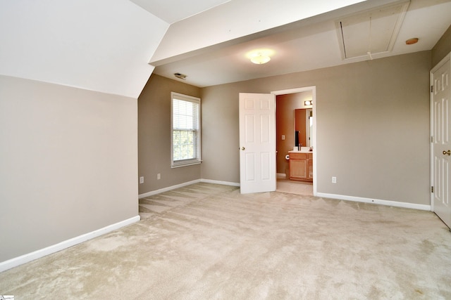 additional living space with lofted ceiling and light colored carpet