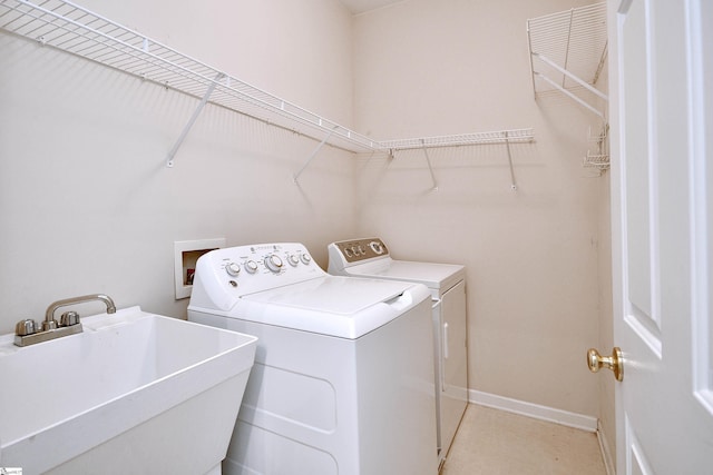 laundry area with sink and washer and clothes dryer