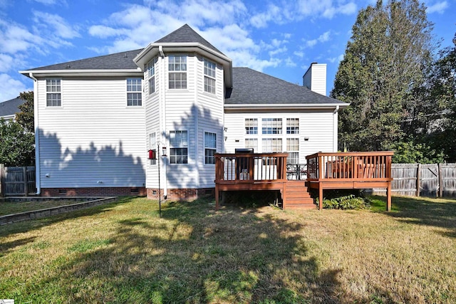 back of property with a deck and a lawn