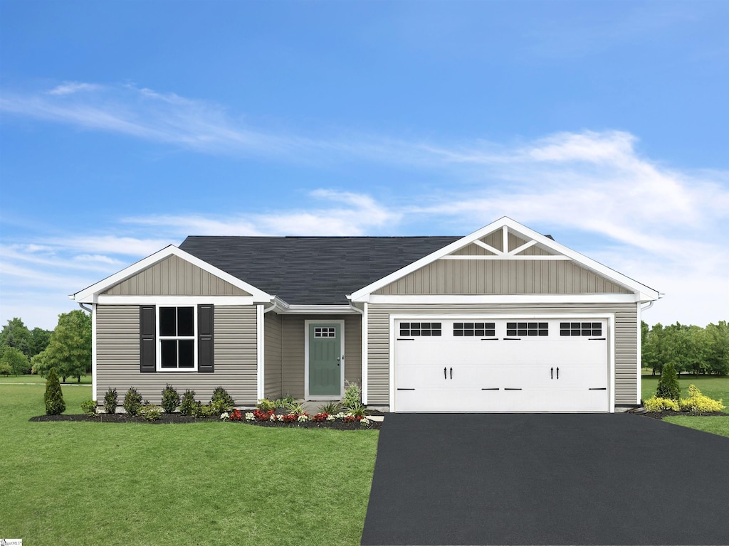 view of front of house with a front yard and a garage