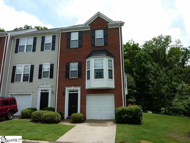 view of property featuring a front yard and a garage