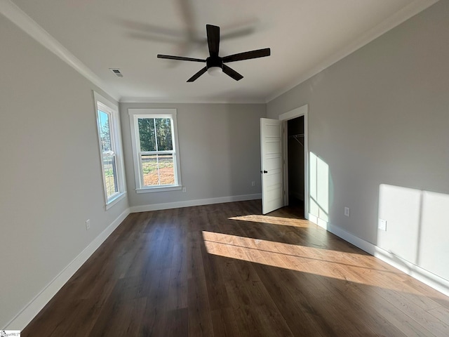 unfurnished room featuring crown molding, dark hardwood / wood-style flooring, and ceiling fan