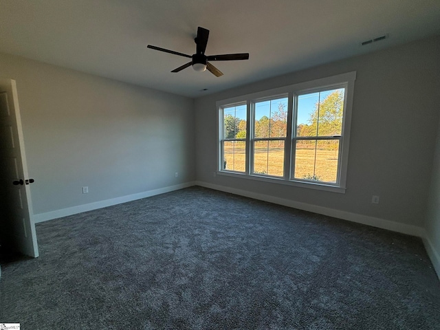 carpeted spare room featuring ceiling fan