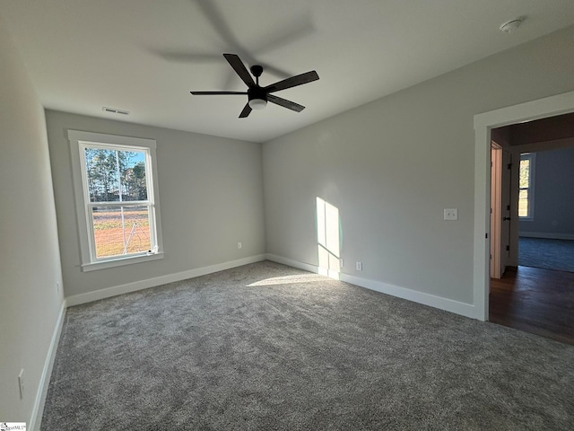 empty room featuring dark colored carpet and ceiling fan