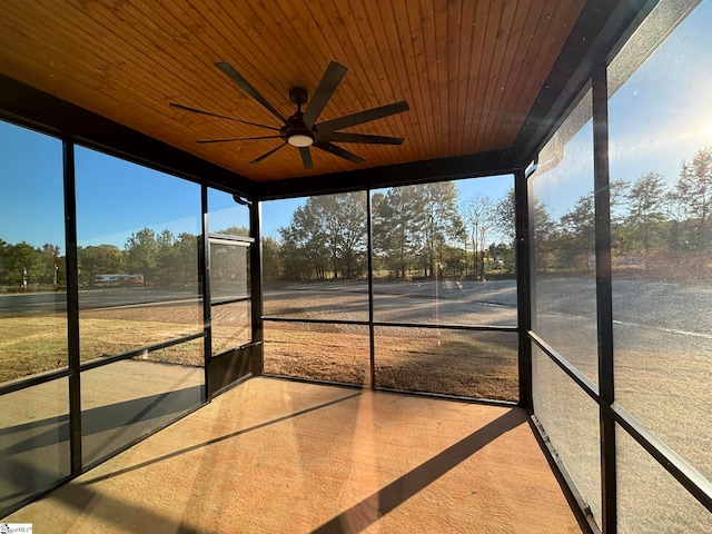 unfurnished sunroom featuring wooden ceiling and ceiling fan