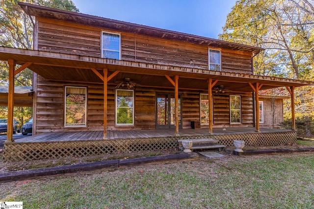 view of front of property with a deck and a front yard