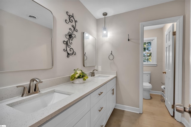 bathroom with vanity, toilet, and tile patterned flooring