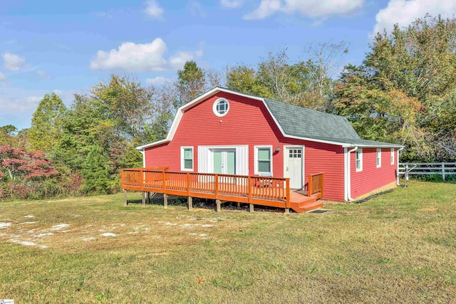 back of house featuring a deck and a lawn