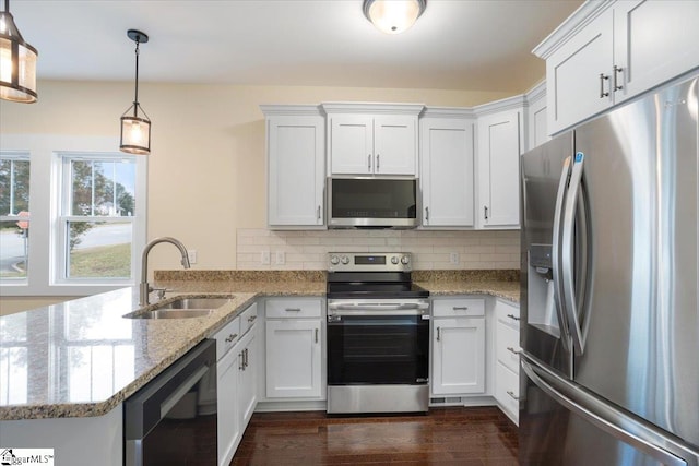 kitchen featuring white cabinets, stainless steel appliances, sink, and pendant lighting