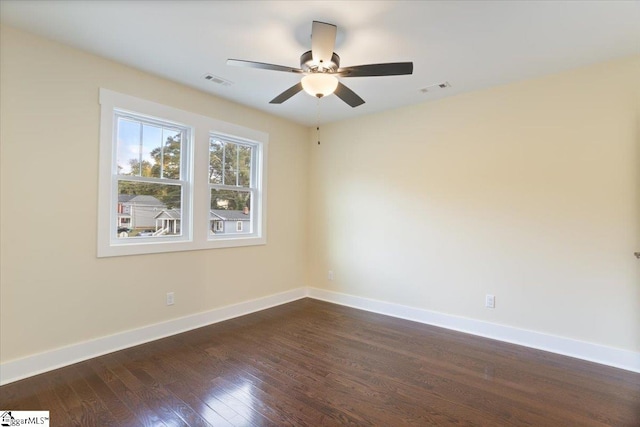 spare room with ceiling fan and dark hardwood / wood-style flooring