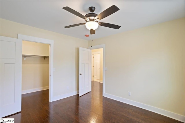 unfurnished bedroom featuring a closet, ceiling fan, and dark hardwood / wood-style flooring