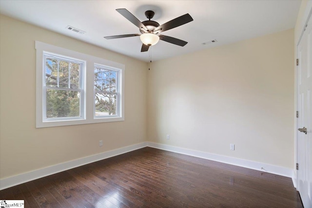 spare room featuring ceiling fan and dark hardwood / wood-style flooring