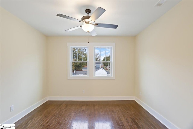 empty room featuring ceiling fan and dark hardwood / wood-style flooring