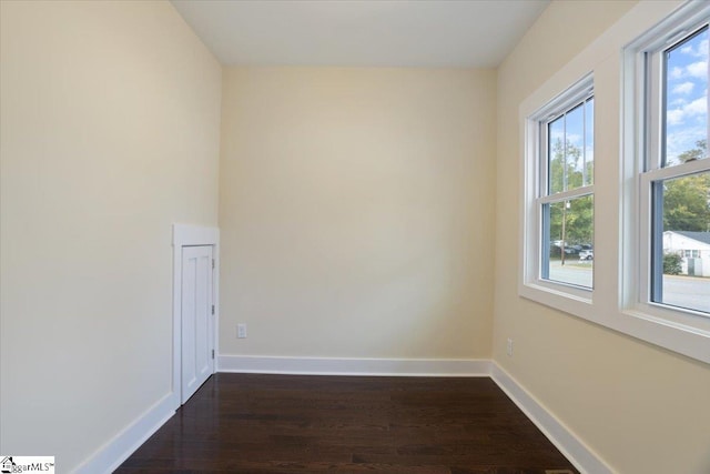 unfurnished room featuring dark wood-type flooring