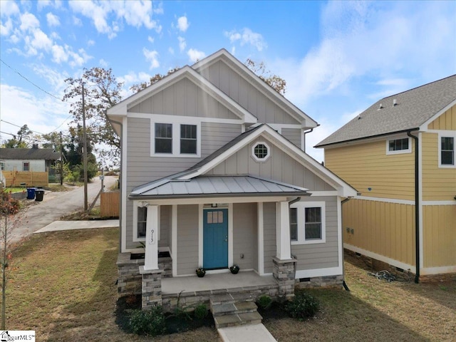 view of front of home with a porch and a front lawn