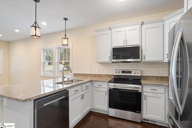 kitchen featuring white cabinetry, dark hardwood / wood-style floors, sink, pendant lighting, and stainless steel appliances