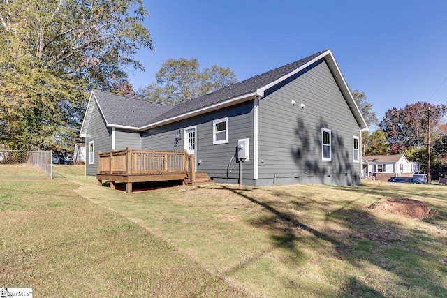 rear view of property featuring a yard and a deck