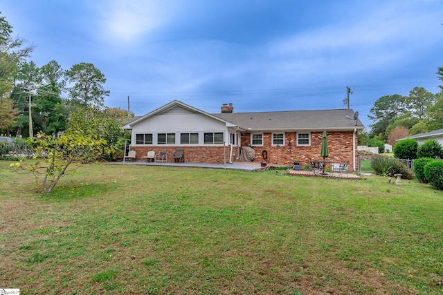 back of house featuring a patio and a lawn